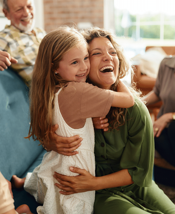 Happy mother and daughter embracing during family's time at home